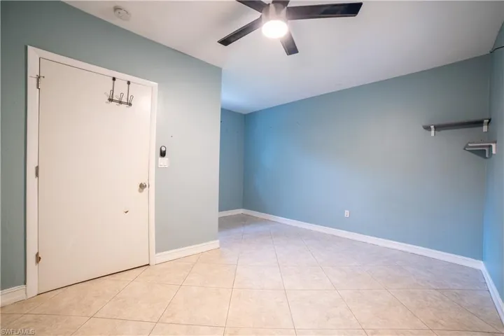 Spare room featuring light tile patterned flooring and ceiling fan