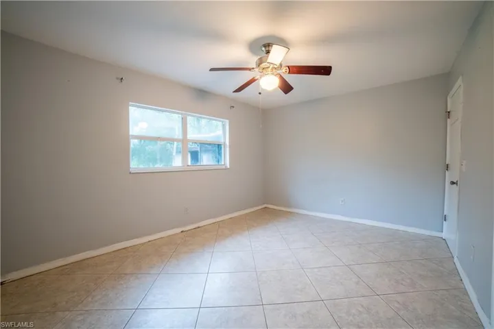 Spare room featuring light tile patterned flooring and ceiling fan
