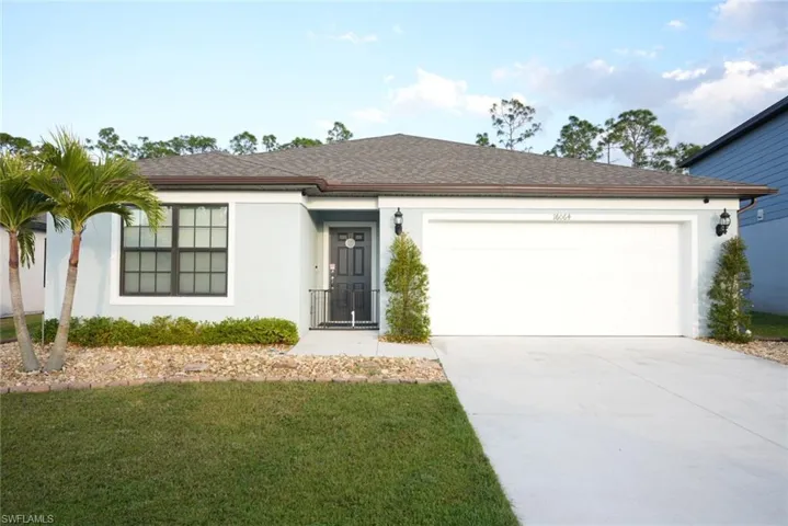 Ranch-style home with a garage and a front yard