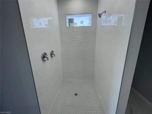 Primary Bathroom featuring tiled shower