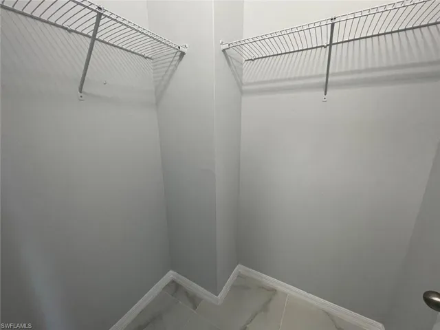Walk in closet featuring tile floors