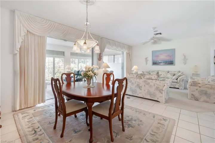 Dining room featuring ceiling fan, light tile patterned floors, and plenty of natural light