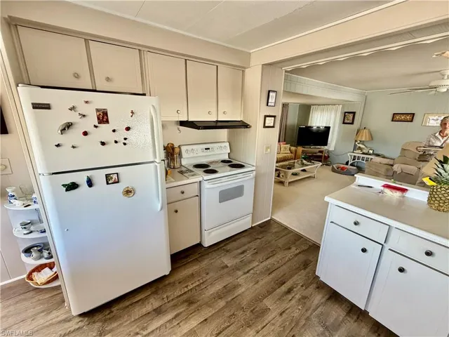 Kitchen with new refrigerator, stove and check out the beautiful wood flooring.