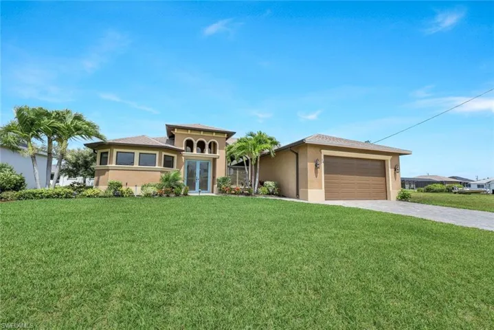 View of front of house featuring a garage and a front yard