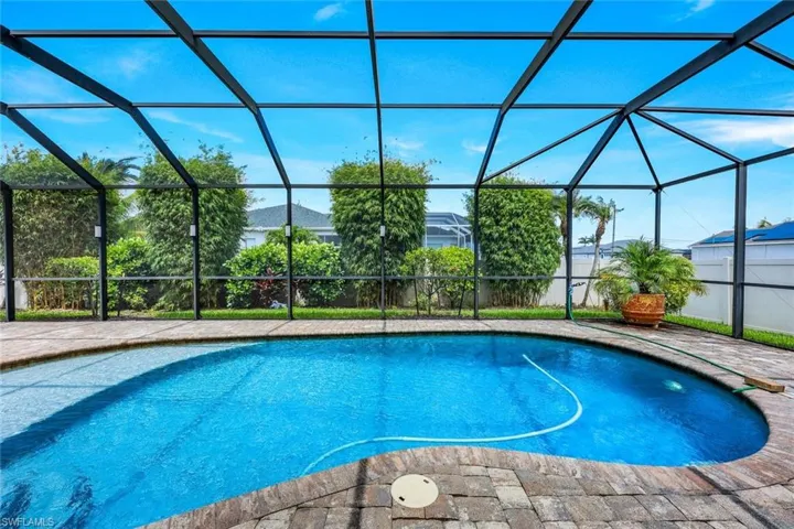 Western Exposure! View of swimming pool with a lanai
