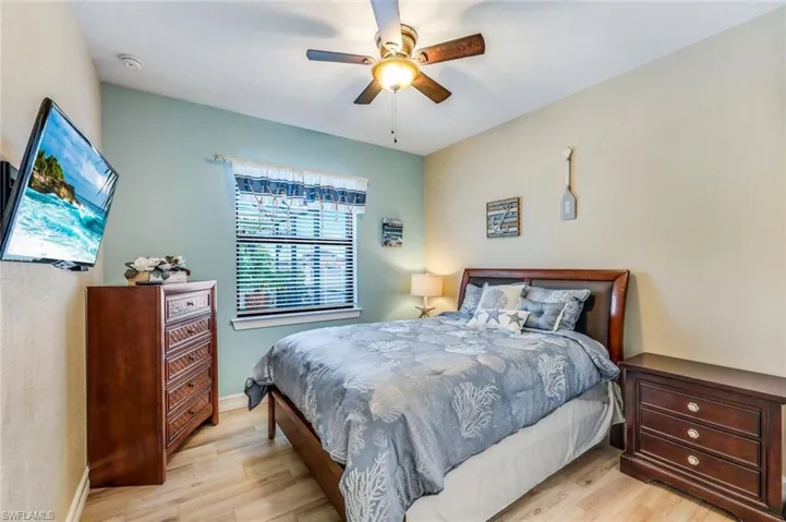 Bedroom with light hardwood / wood-style floors and ceiling fan