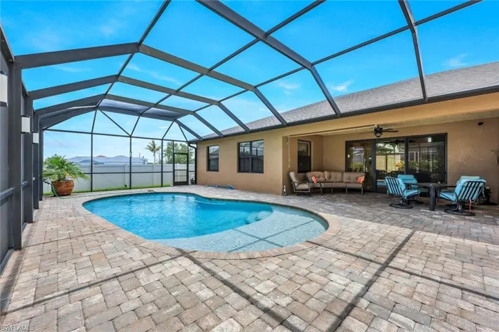 View of swimming pool with a lanai, an outdoor living space, a patio area, and ceiling fan