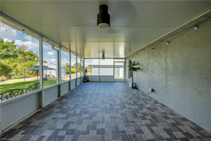 Unfurnished sunroom with a ceiling fan