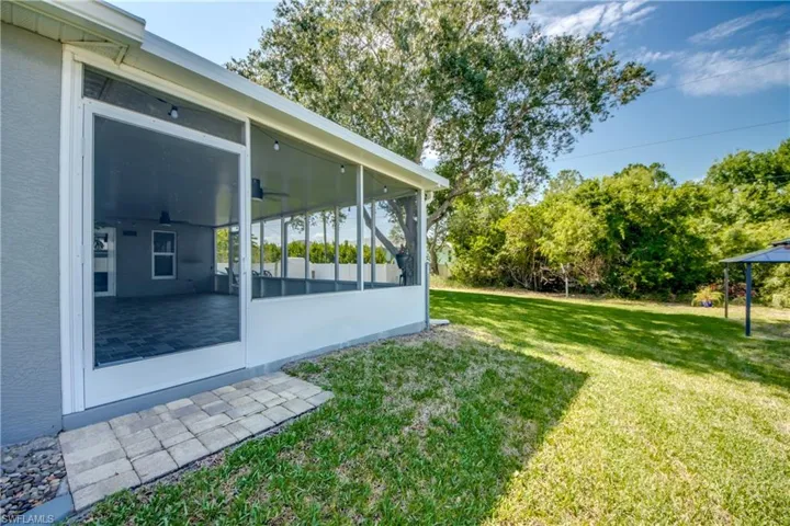 View of green lawn with a sunroom