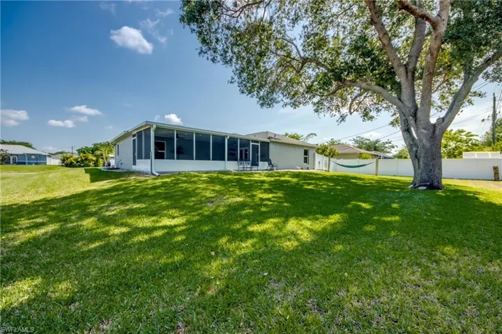 Back of property with a sunroom