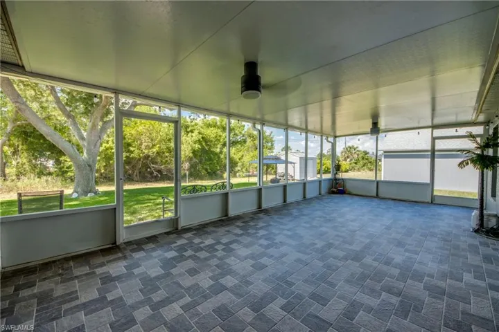 Unfurnished sunroom with ceiling fan