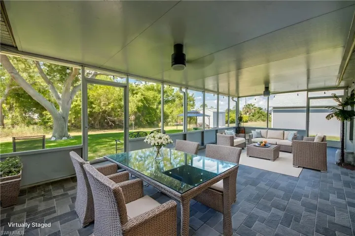 Sunroom / solarium with an outdoor living space, a ceiling fan, and outdoor dining space