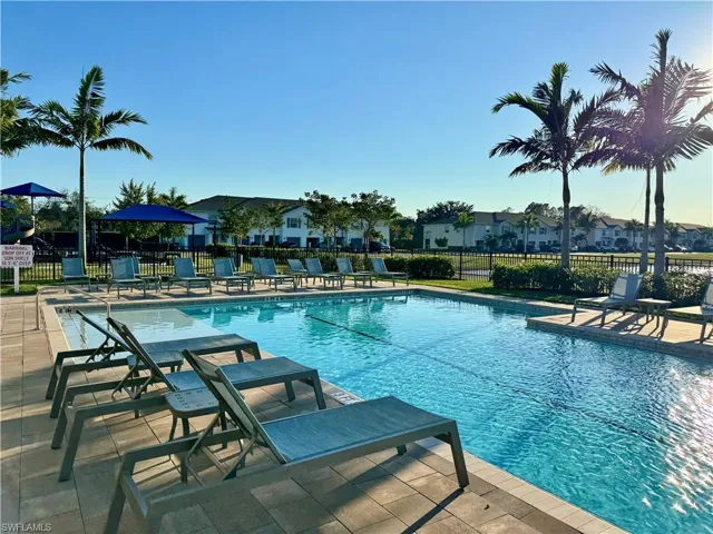 Community pool featuring a patio area and a residential view