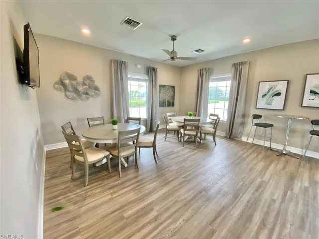 Dining space featuring light wood finished floors, ceiling fan, and recessed lighting