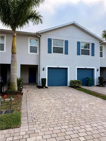 View of front of house featuring decorative driveway and stucco siding
