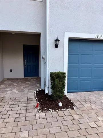 View of exterior entry with stucco siding