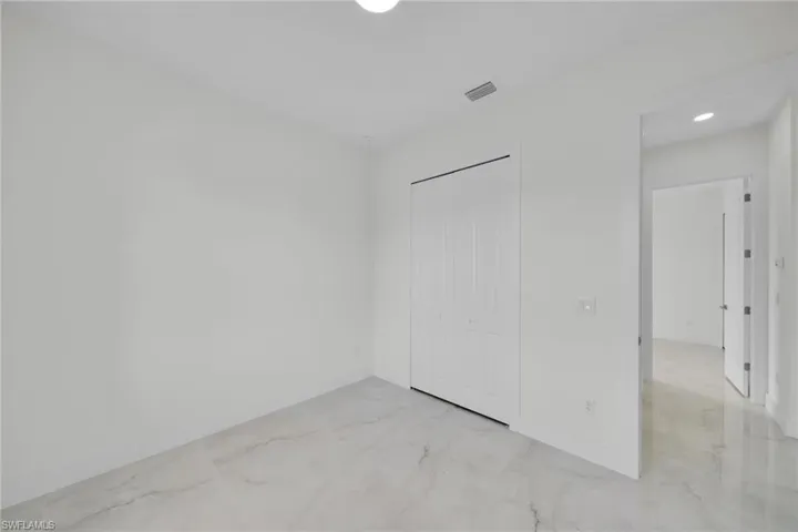 Unfurnished bedroom with baseboards and a closet