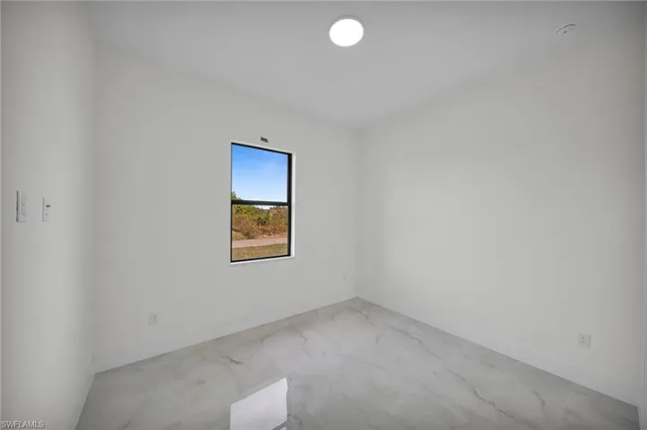 Unfurnished room featuring baseboards