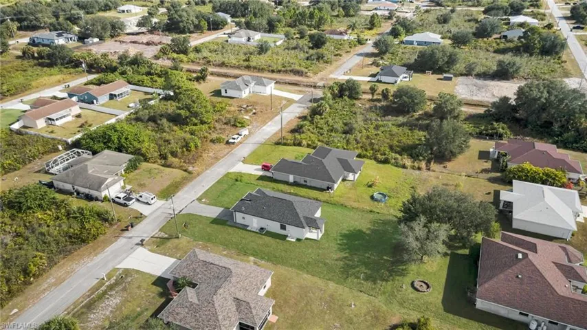 Aerial view of property's location featuring nearby suburban area
