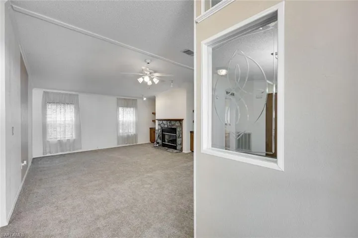 Great room features brand new neutral carpet and a wood-burning fireplace for those few chilly nights in paradise!