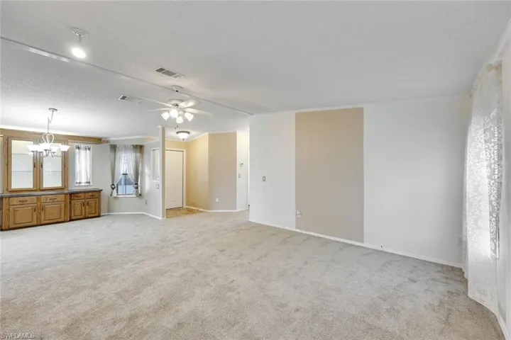 Immense Living Room with view to Foyer and built-in cabinetry.