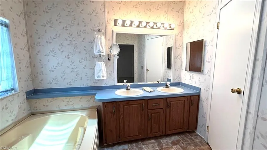 Primary Bathroom features a separate tub and shower along with dual sinks.