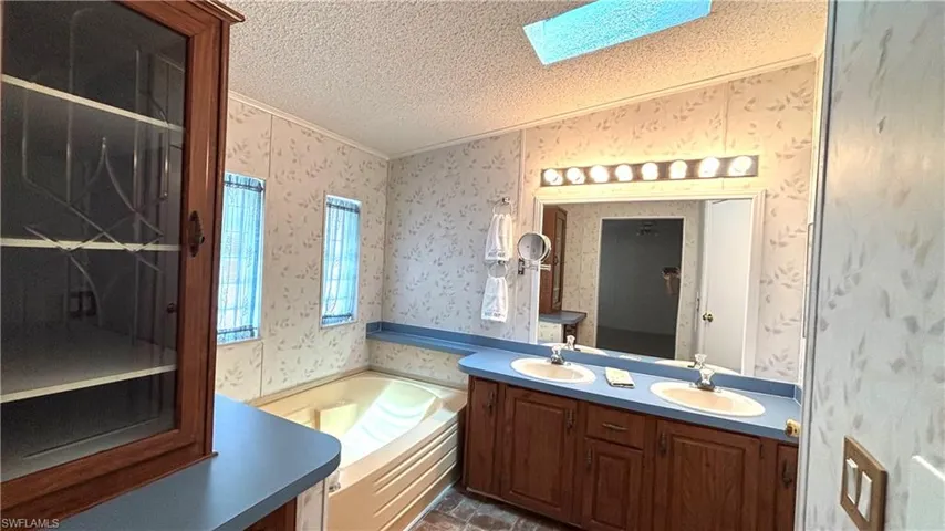 Beautiful wood cabinetry, separate tub, dual sinks, and a SKYLIGHT in the Primary Bathroom!