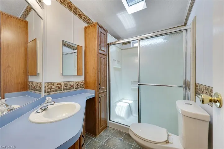Shower in the second bathroom. Note the skylight in the ceiling!