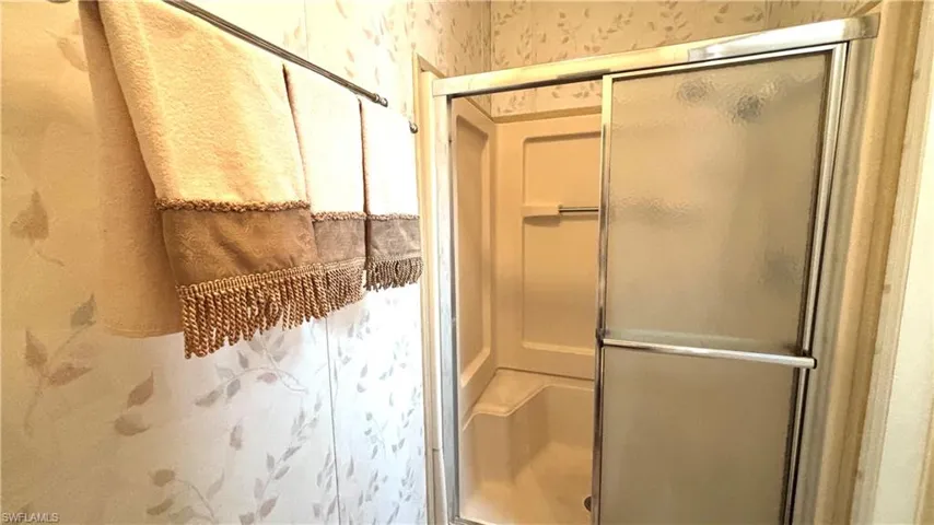 Shower in Primary Bathroom includes a seat and handrail for safety.