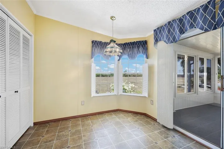 Eat-in Kitchen with Laundry Suite to the left and Florida Room to the right.