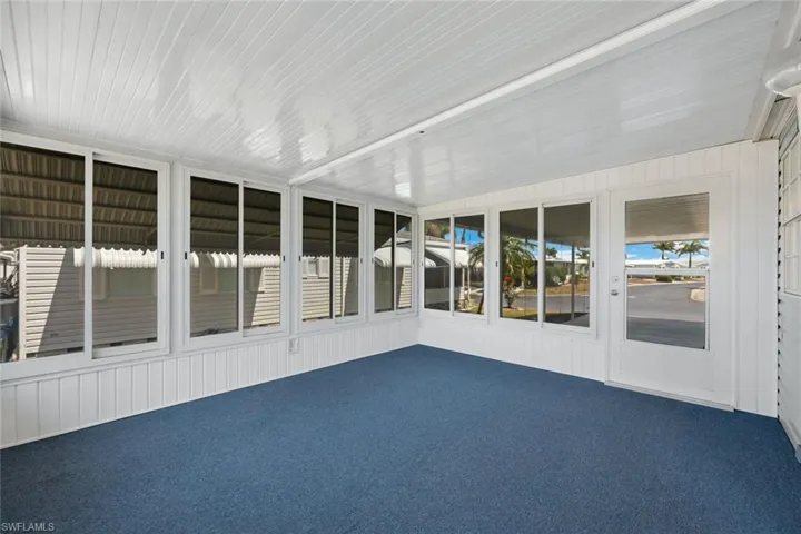 12'x15' Florida Room has brand new indoor/outdoor carpet, new easy-glide vinyl impact windows, and awnings for energy savings and weather protection.