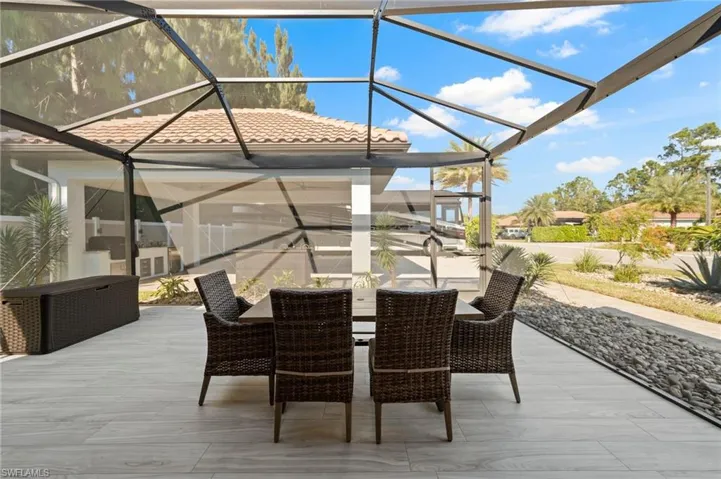 View of patio / terrace with a lanai, outdoor dining area, and a sunroom