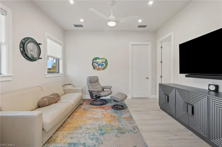 Living area with recessed lighting, light wood-type flooring, and ceiling fan