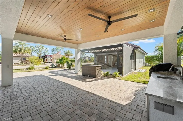 View of patio / terrace with ceiling fan and a sink
