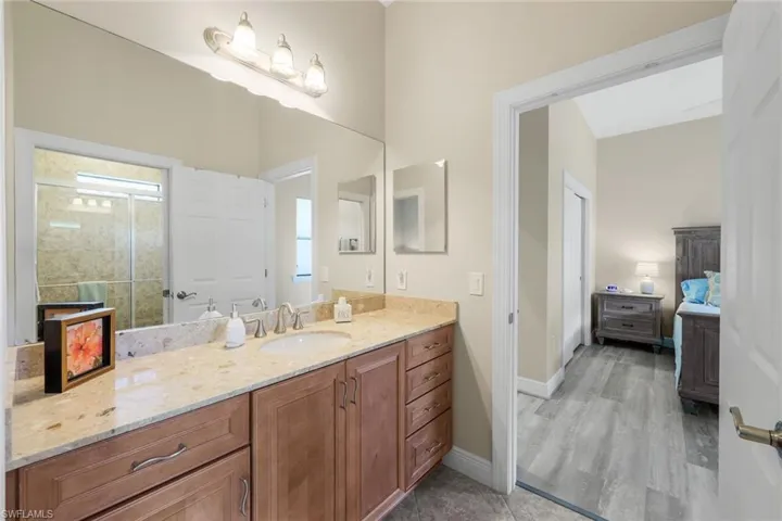 Guest bathroom with vanity and wood-type flooring