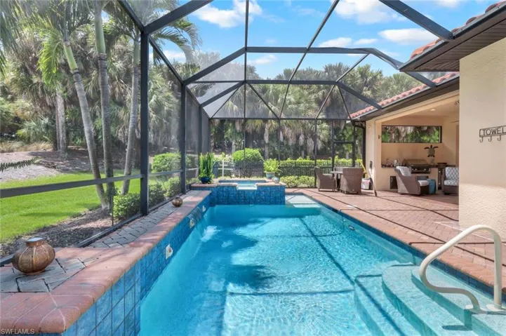 View of swimming pool featuring an outdoor living space, a lanai, in ground hot tub, and a patio area