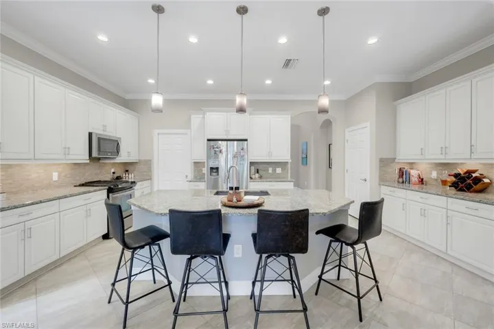 Kitchen island with sink and stainless steel appliances