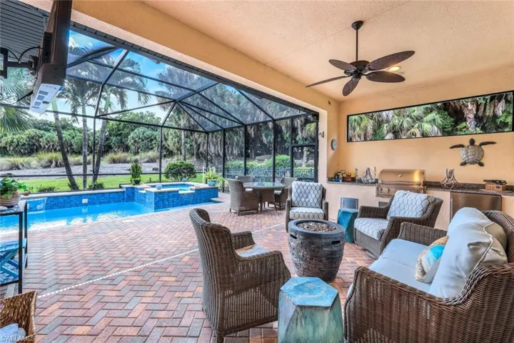 Patio / terrace featuring an outdoor kitchen, fire pit, ceiling fan and grilling area