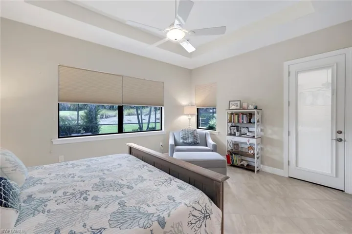 Primary bedroom featuring ceiling fan and door leading out to lanai