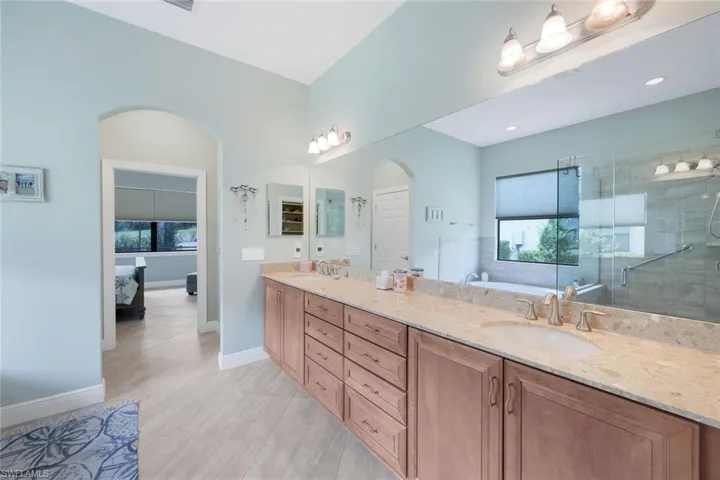 Primary bathroom with vanity and separate shower and tub