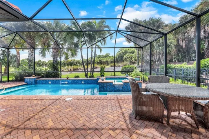 Pool featuring water feature, in ground hot tub, and a patio area