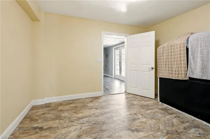 Spare room featuring baseboards and stone finish flooring