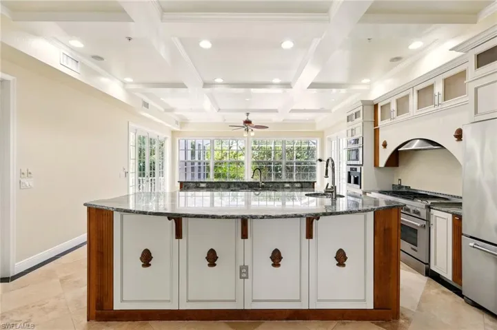 Kitchen with stainless steel appliances, a sink, recessed lighting, a large island, and plenty of natural light