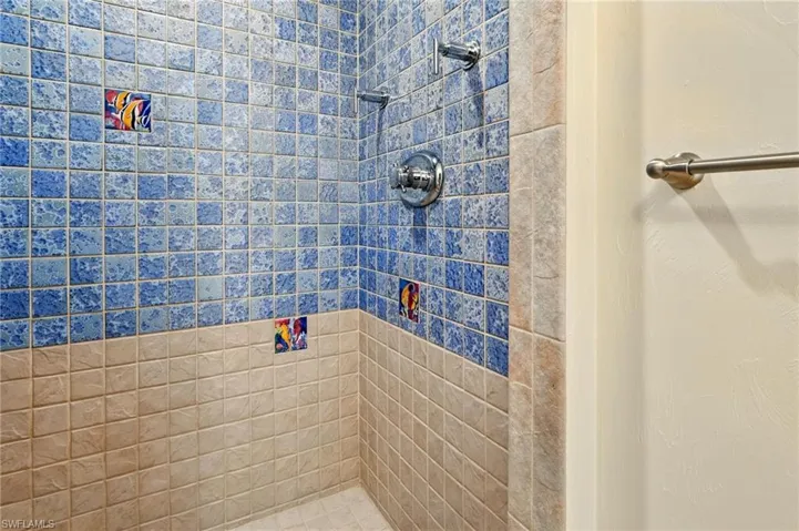 Full bath featuring tiled shower
