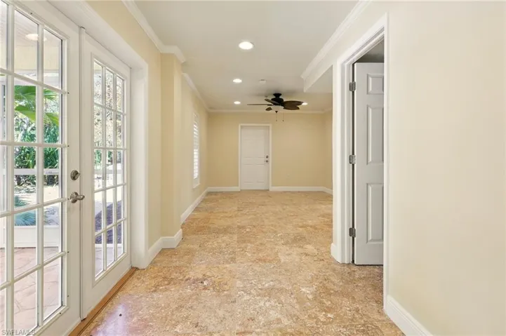 Corridor featuring recessed lighting, ornamental molding, baseboards, and french doors