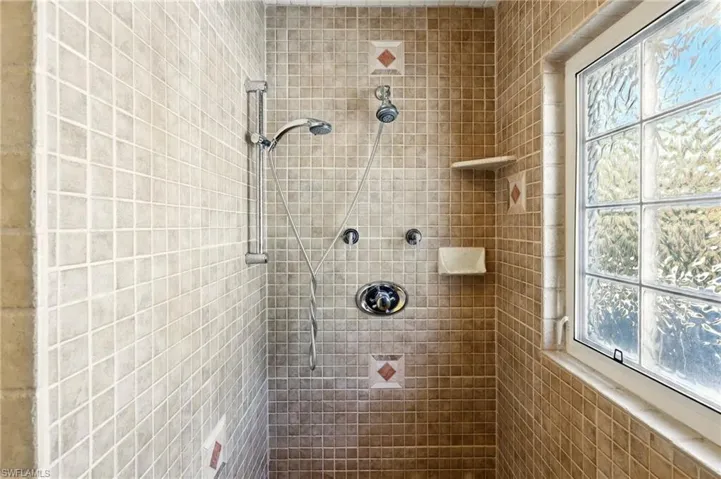 Full bath featuring a tile shower
