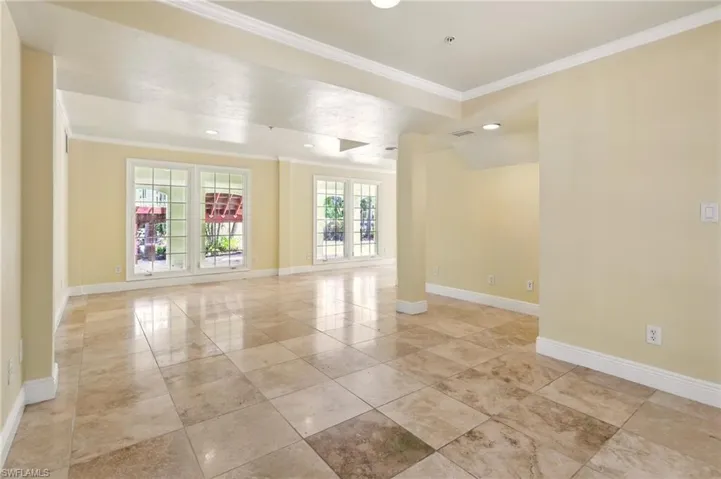 Unfurnished room featuring crown molding, baseboards, and recessed lighting