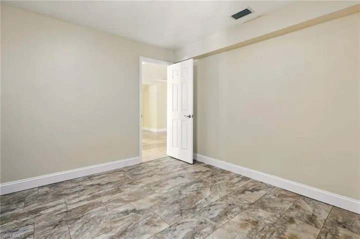 Unfurnished room featuring baseboards