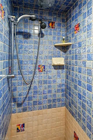 Full bath featuring tiled shower