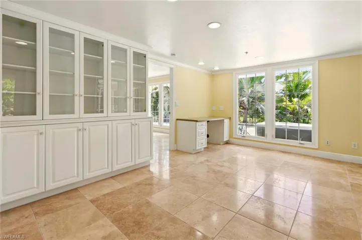 Empty room featuring baseboards, ornamental molding, and recessed lighting